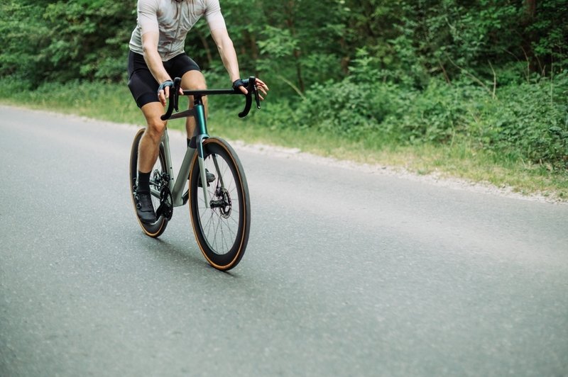 men cycling with comfort road bike on the road